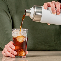 Pouring cold brew from the Toddy Go into a glass
